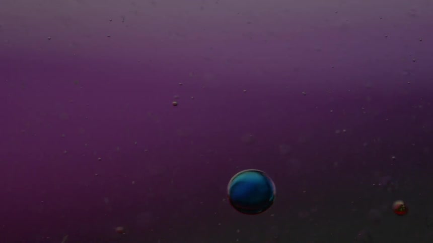 Colors are flashing as colored balls flow through liquid