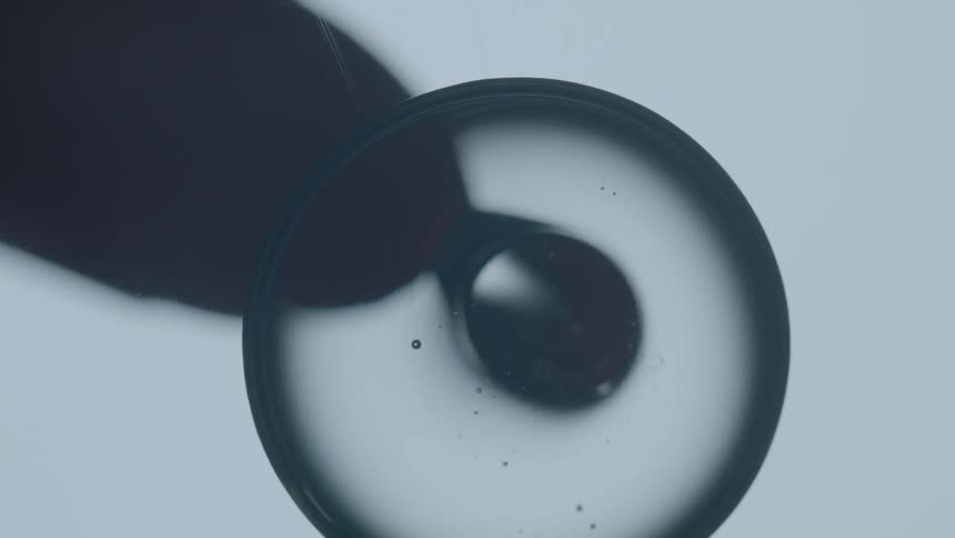 Liquid being dropped into a circle and magnified