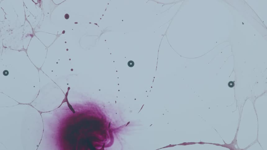 The white liquid has purple colors and bubbles all over