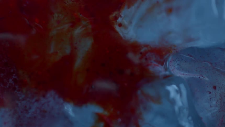 A red liquid flows over and inundates clear crystals