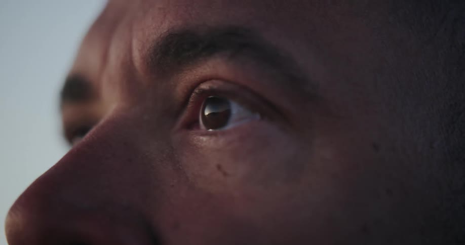 A man opens his eyes with intensity