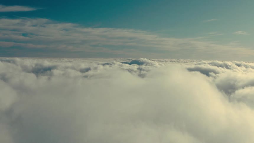 Clouds are shown from above instead of below in a cloud blanket in the sky