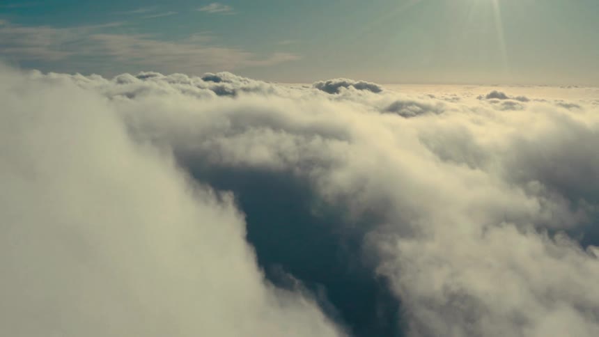 Light peeks through the thick clouds in this aerial view