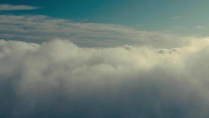 Several dense white clouds in a blue sky