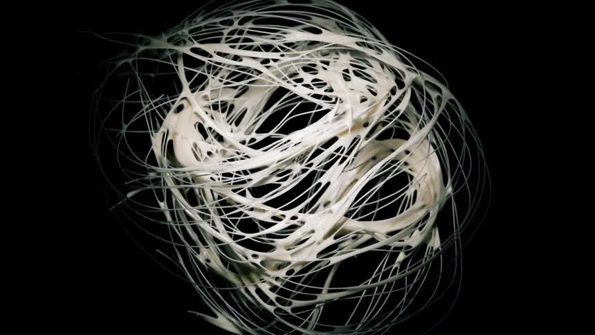 Abstract globe of white paint crumbling abstractly against a black background