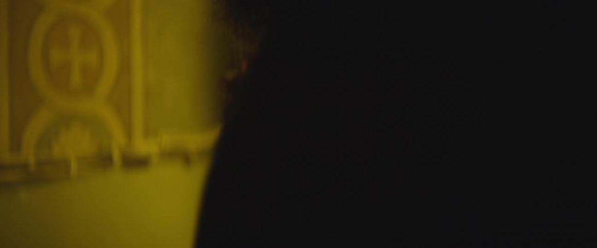 Smoke billows around a man with a beard