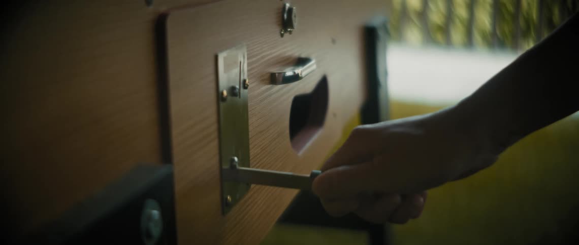 Person feeds coin into a coinoperated machine then retrieves it after ejecting it