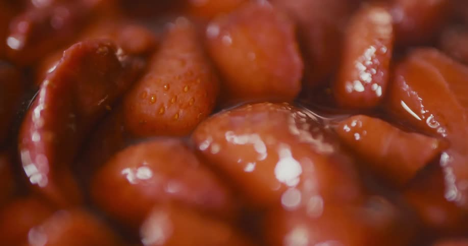 Strawberries are being mixed in sauce