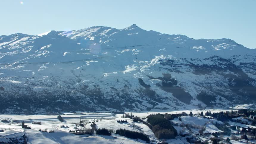 Coronet Peak Ski Area covered in snow under a clear blue sky