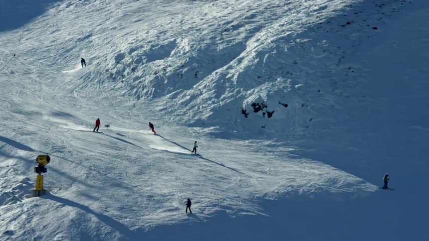 Aerial view of skiers descending a snowy mountain slope