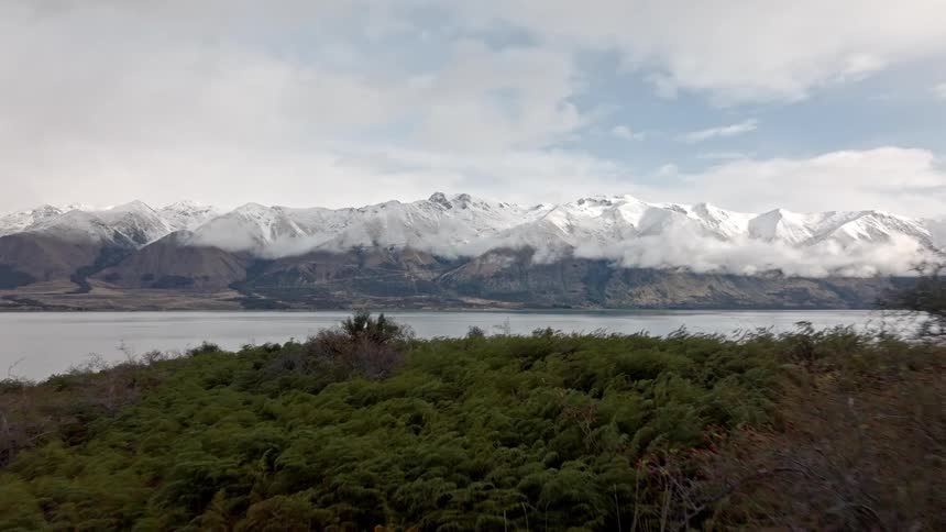 A lake and snow capped mountain range landscape