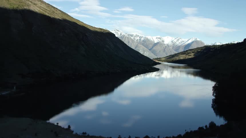 A mountain landscape with a lake in the center of it