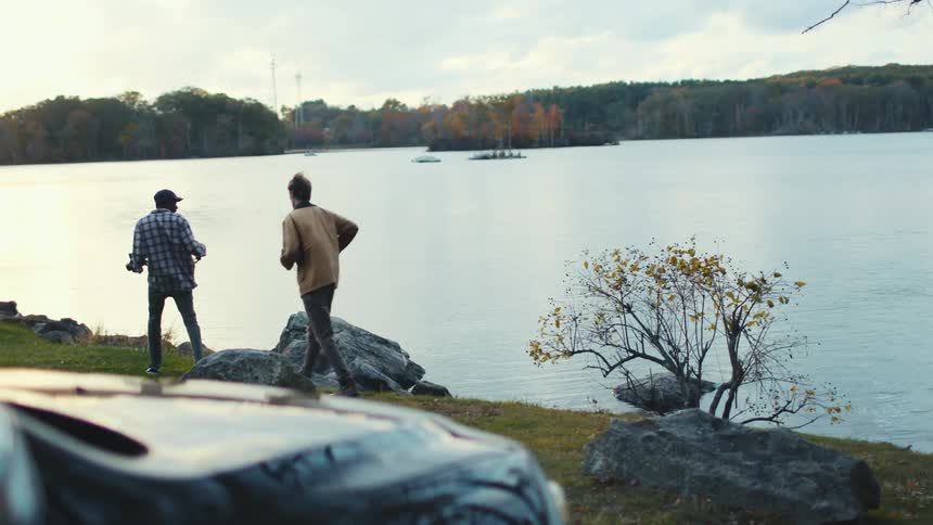 Two young men exploring a New England lake
