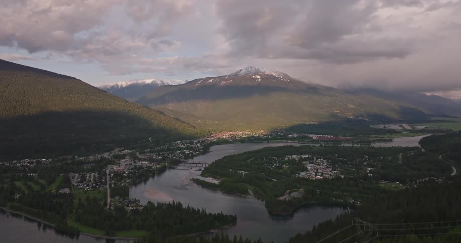 Aerial view of a small town located in a valley surrounded by mountains and crossed by a river