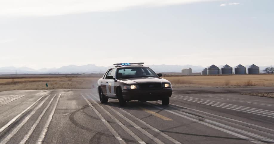 Police car moving on a road with its lights activated