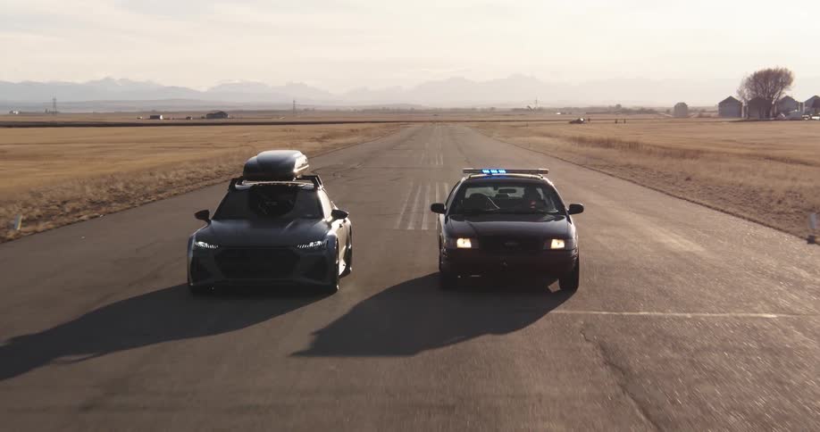A police car spins out as it chases another car