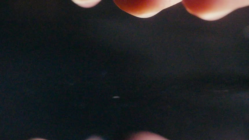 A person dips their hand in water