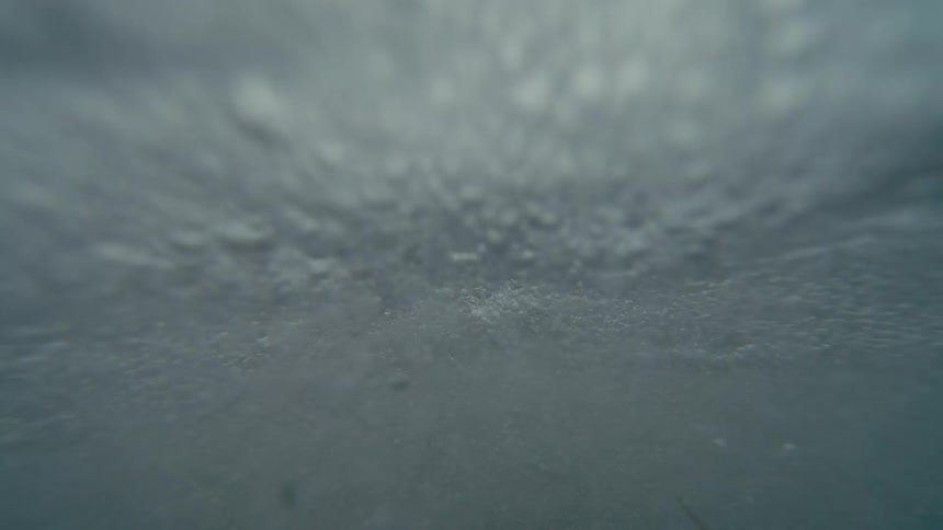 Close up of small waves breaking in the shoreline