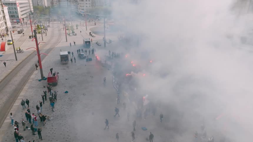 A crowd of protestors are in front of the building