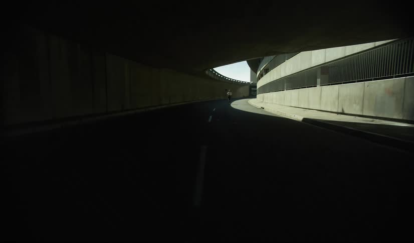 A dark tunnel leading to the lower levels of a building