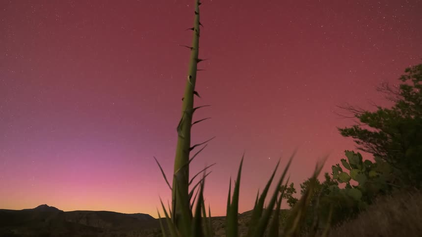 Red pink Aurora in the desert sky