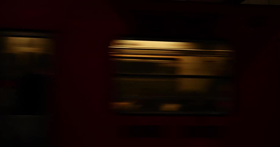 Passengers ride a train at night