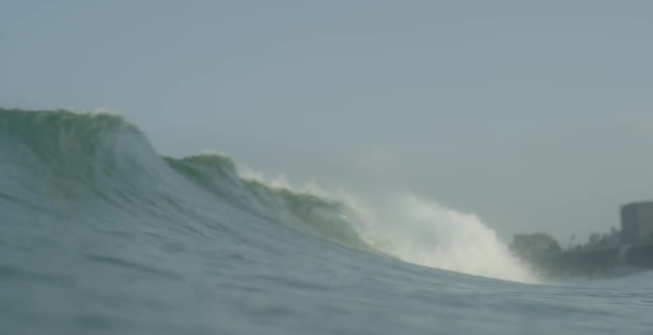 A wave forms and breaches in the ocean