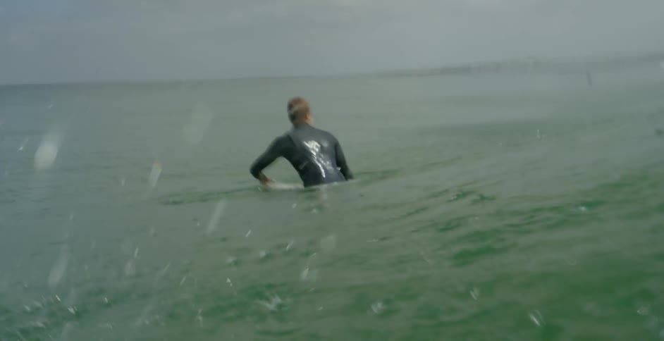 A surfer is waiting for a good wave