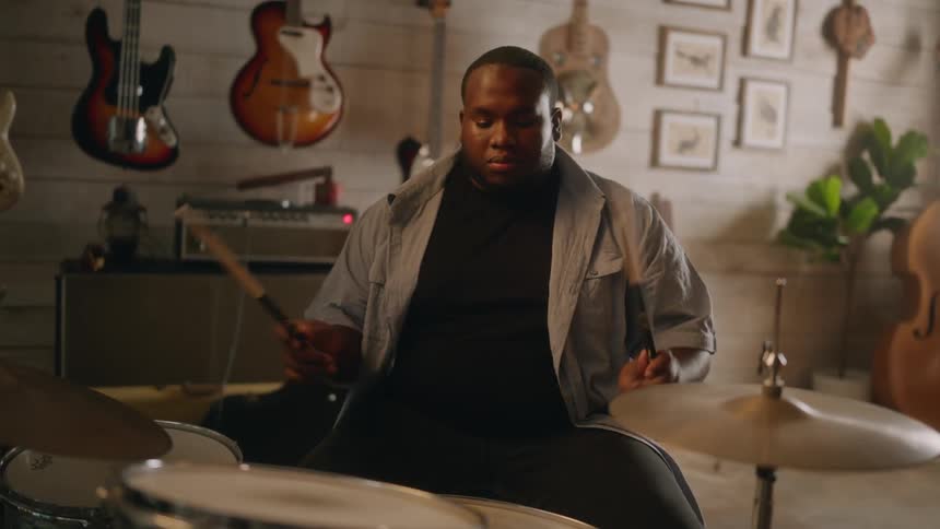 Man sitting playing drums