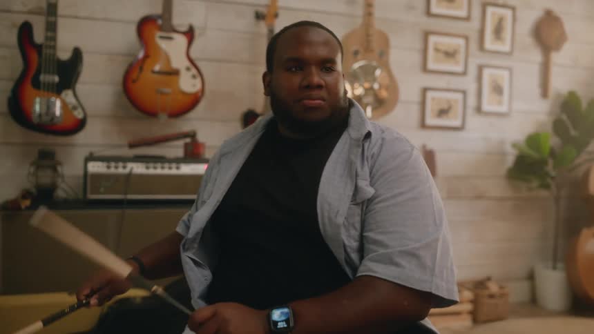 Man playing drums in a room