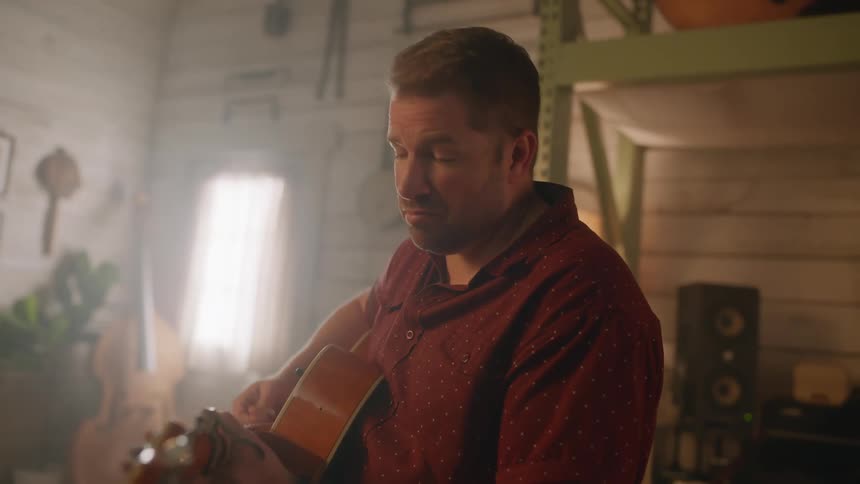 Man playing guitar indoors