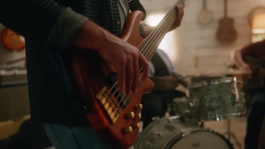 Three men in a band jam together in a room