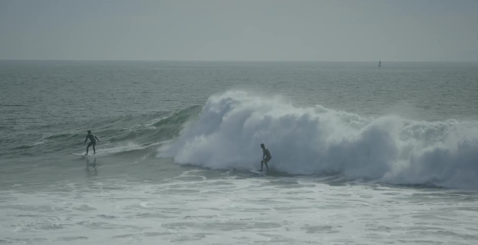 A surfer rides a wave
