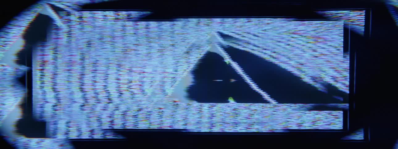 Close up of a distorted triangular shape moving on a screen
