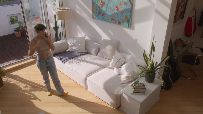 A woman is talking on the phone at home