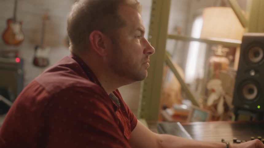 A musician is working on a soundboard