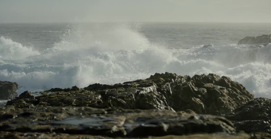 Large ocean waves crashing onto rocks