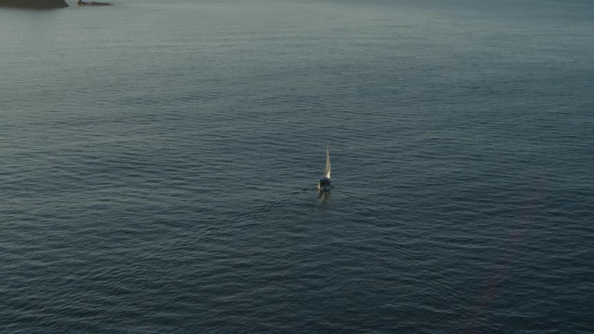 A boat is sailing by the small islands