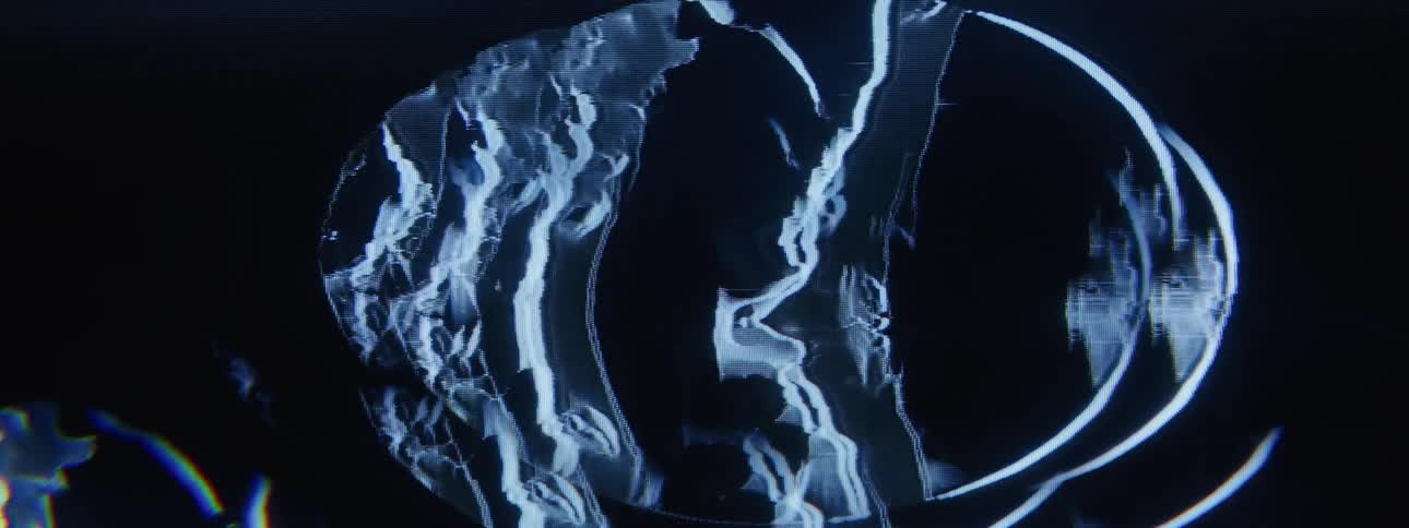 Uneven jagged shapes flow across oval shape on a black background