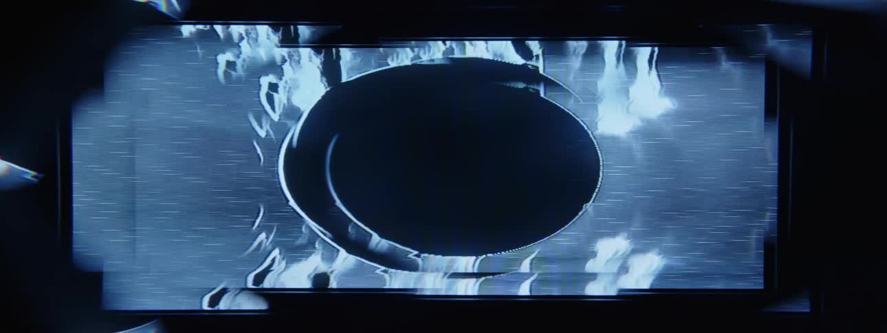 A screen displaying abstract imagery has a dark circle in the middle