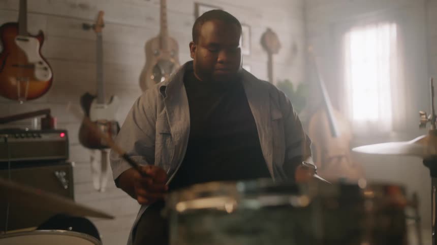 A man is playing drums