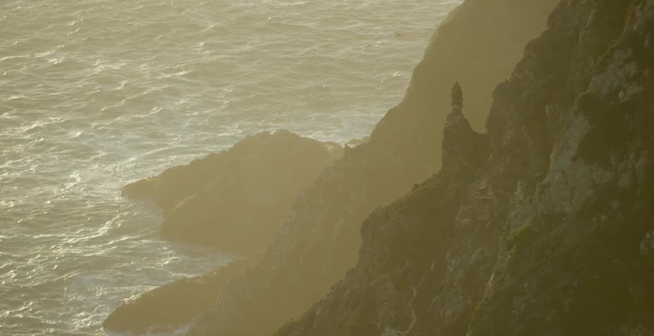 View of the sea below as seen from a rocky mountainous area