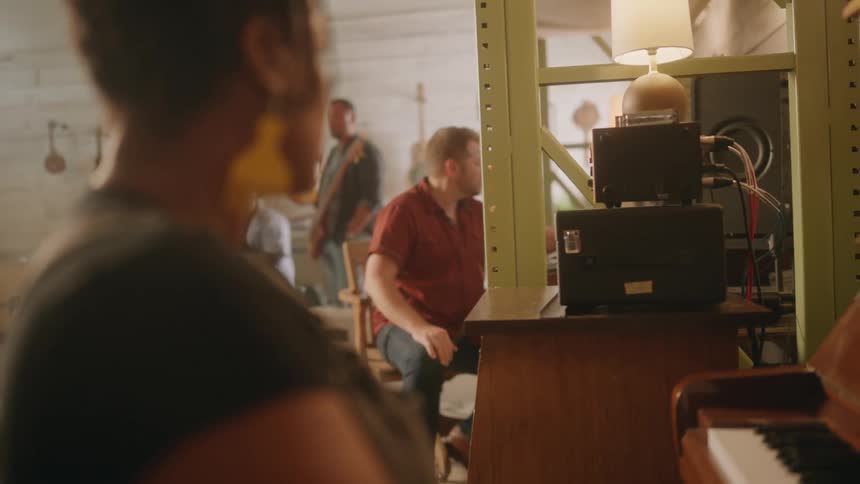 Man and woman sitting and talking in a music studio
