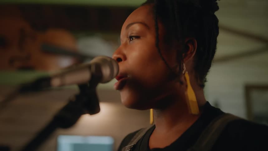 A woman is singing into the microphone