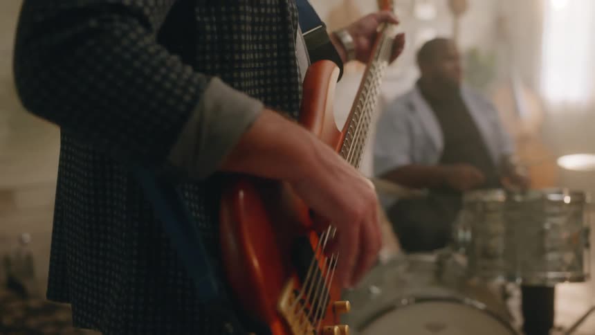 Three people play together in a band