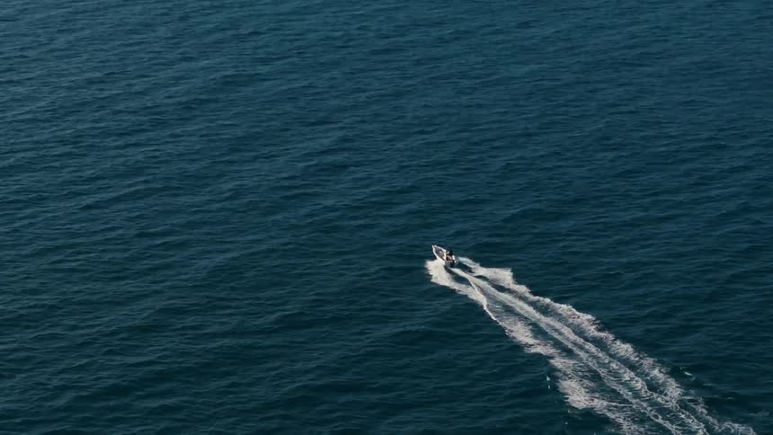 A boat is traveling in the ocean