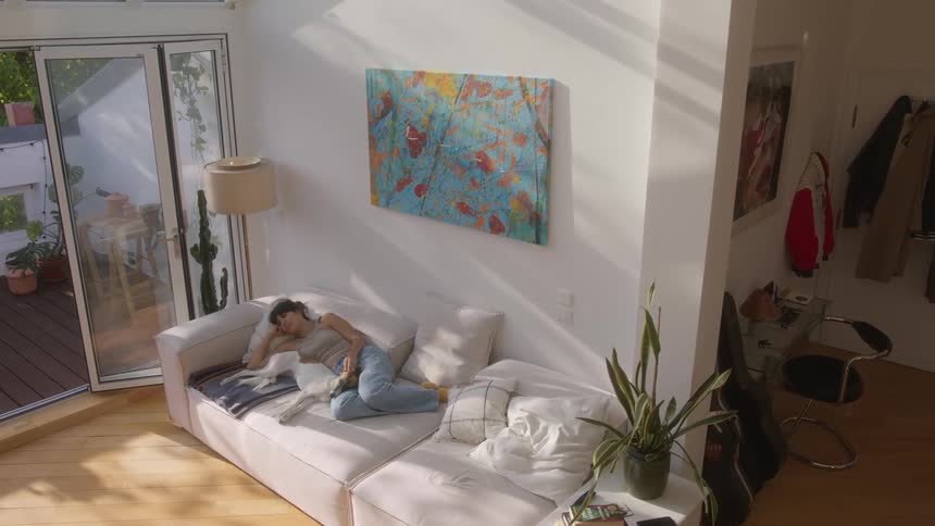 Dog sleeping next to its owner in a room