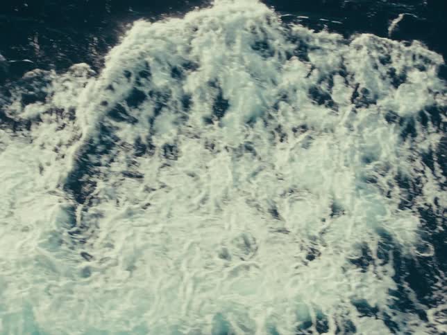 Aerial view of ocean waves moving across the surface of the sea