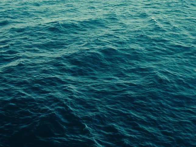 The surface of the ocean with gentle rolling waves