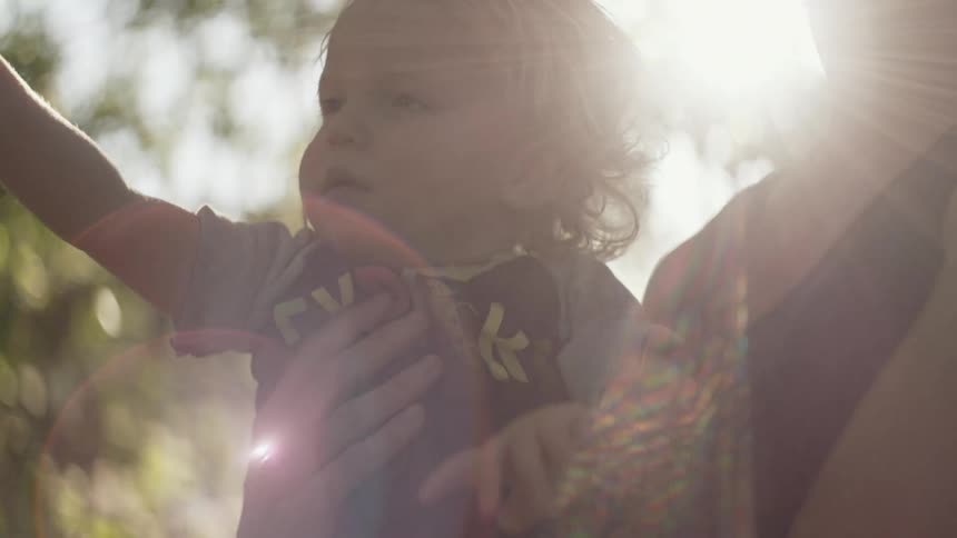 Child holding hand up in the sunlight